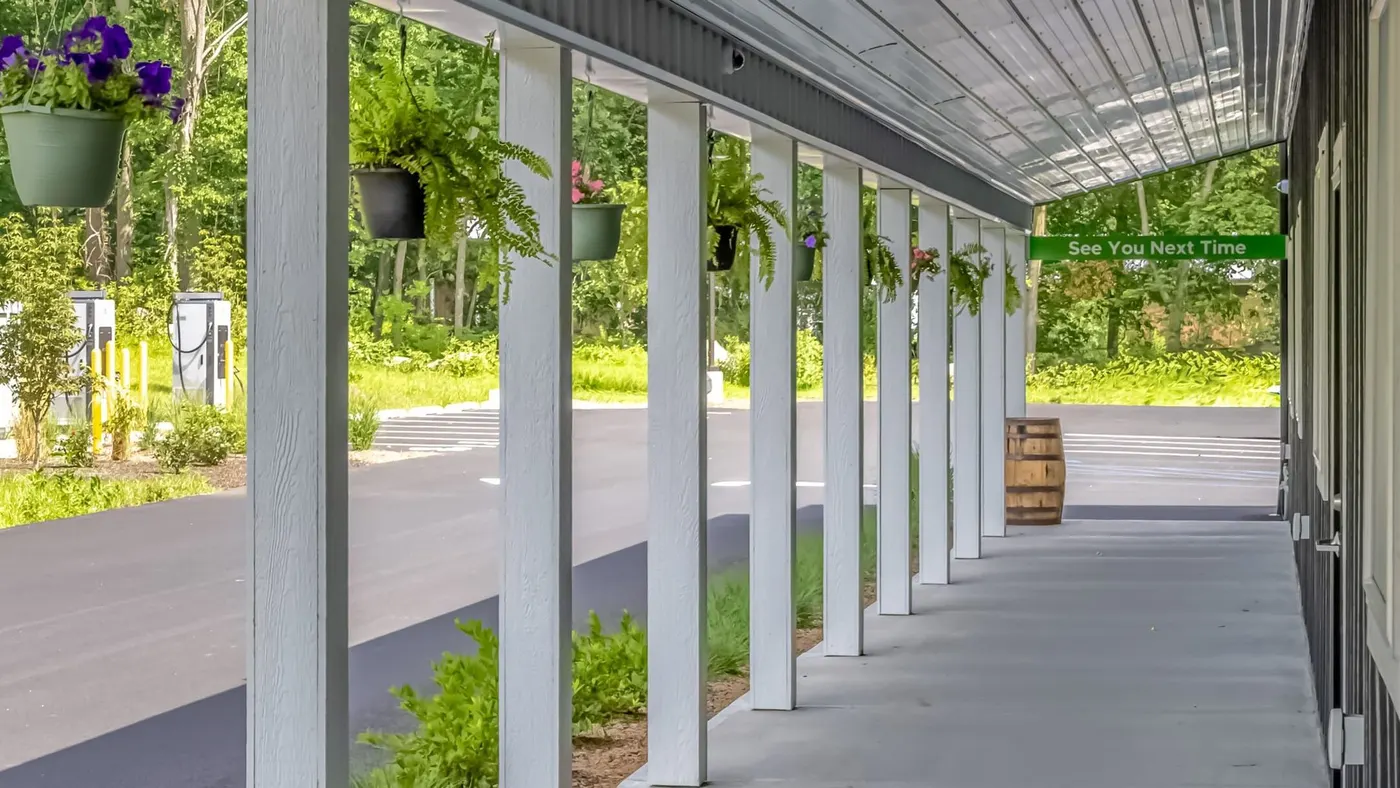 Covered porch of Farmers Choice dispensary with hanging flower baskets