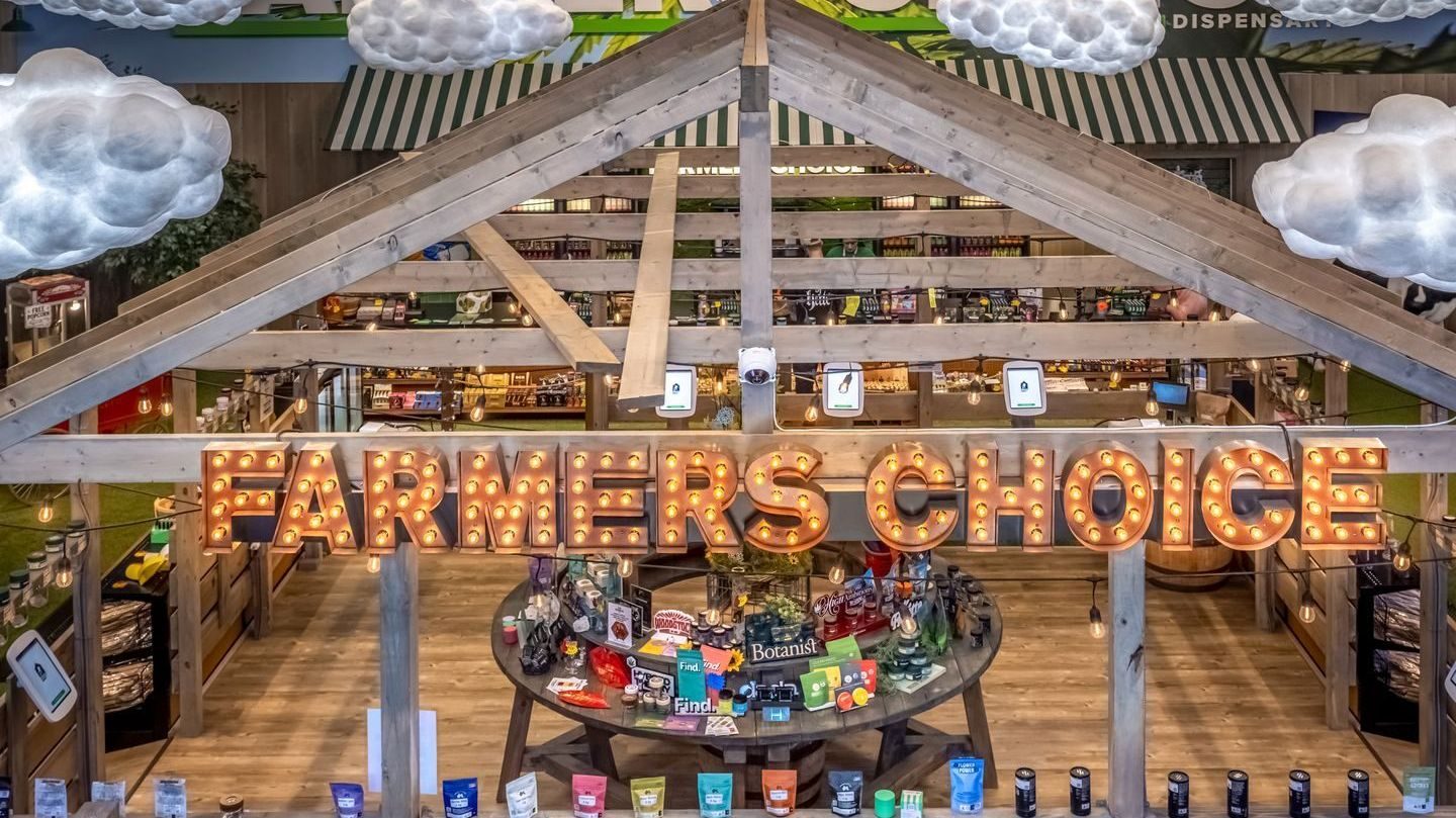 Interior of Farmers Choice dispensary with wooden barn structure and product displays